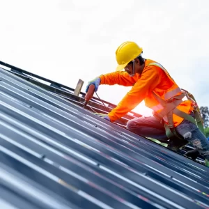 Contractor installing a standing seam metal roof.