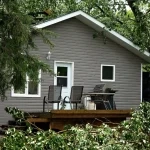 House with downed tree. Storm Damage Roof Repair: What to Do After High Winds or Hail