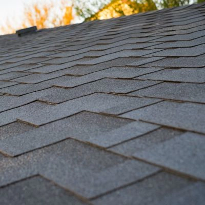 Detailed view of newly installed dark gray architectural shingles on a sloped roof