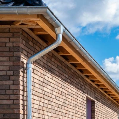 Aluminum gutter and downspout system on a residential brick home in Arden, NC
