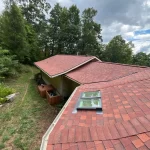 View of a roof with a skylight showcasing a recently completed skylight repair project.
